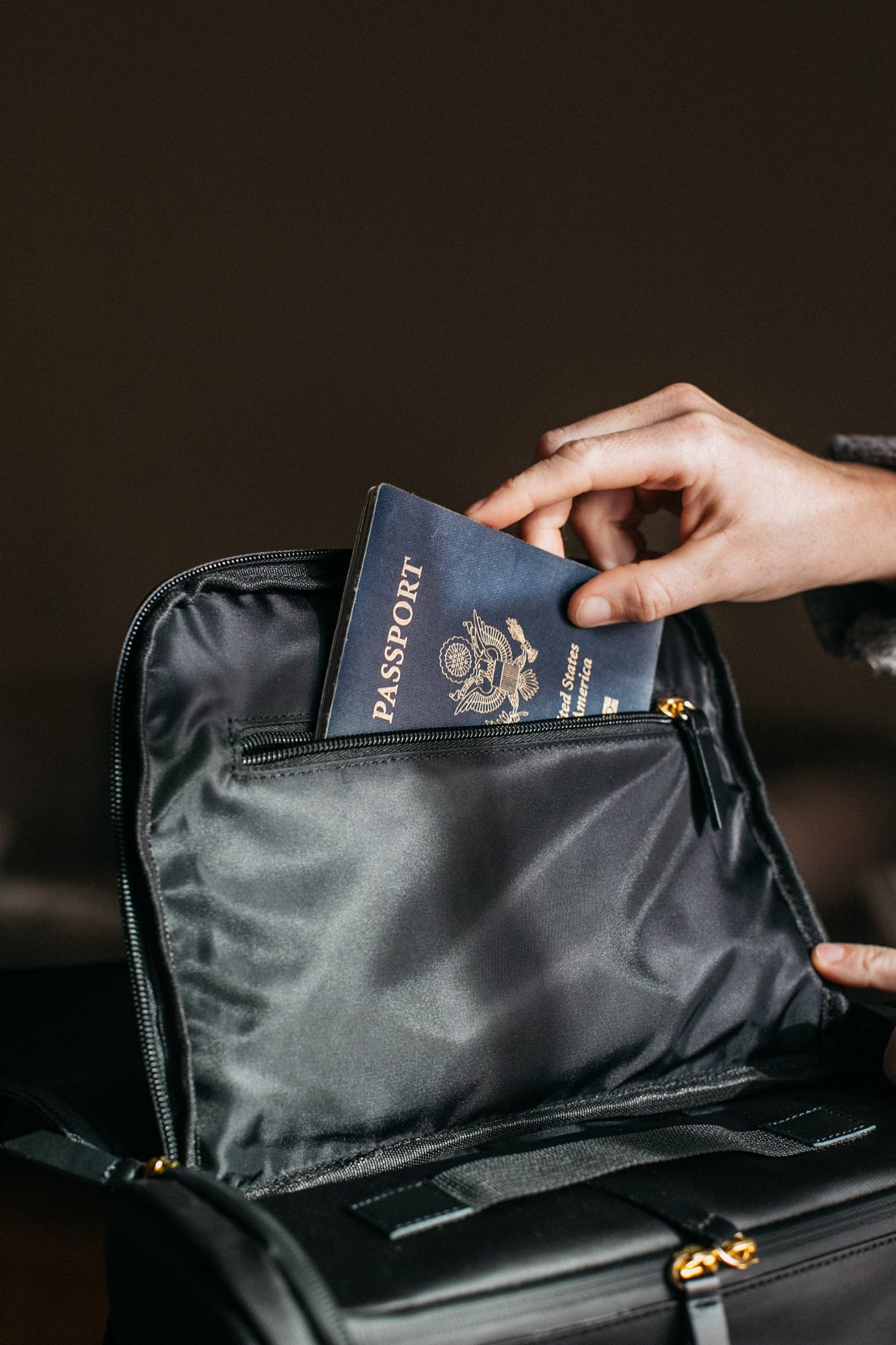 Passport being put into a black bag